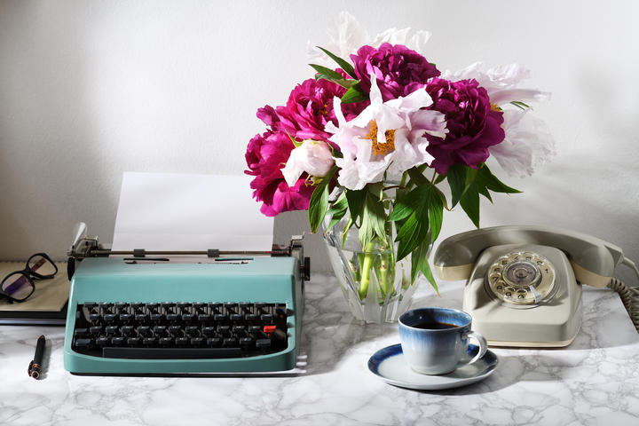 vintage typewriter and rotary telephone, flowers, coffee cup